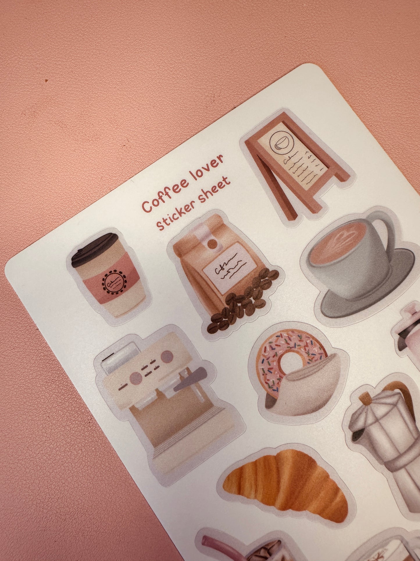 Coffee-themed sticker sheet with various coffee-related illustrations on a pink background