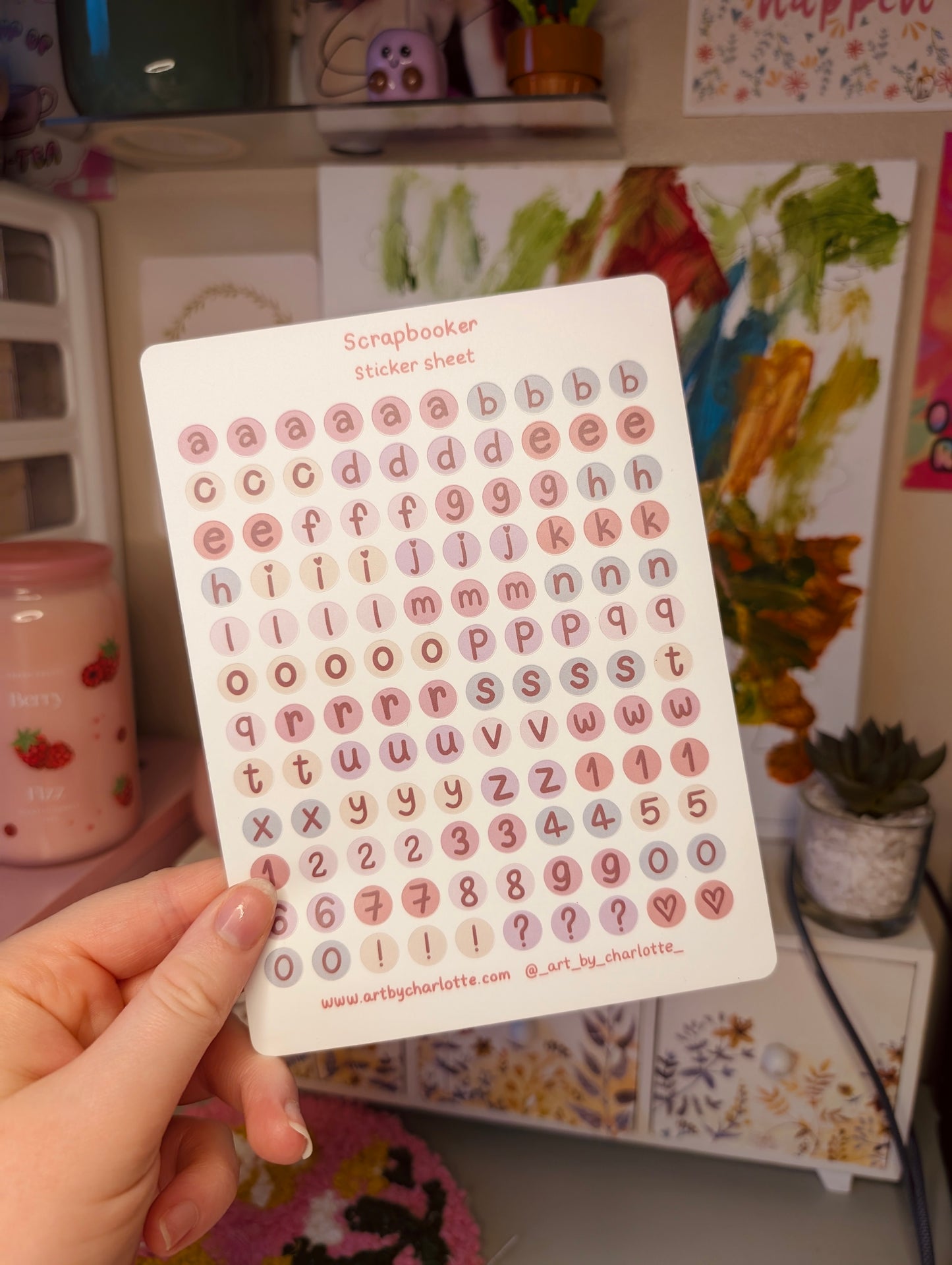 Card with small letters and numbers held by a hand against a colorful background