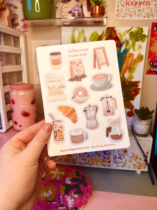 Sticker sheet with coffee-themed illustrations held by a hand in a casual setting.