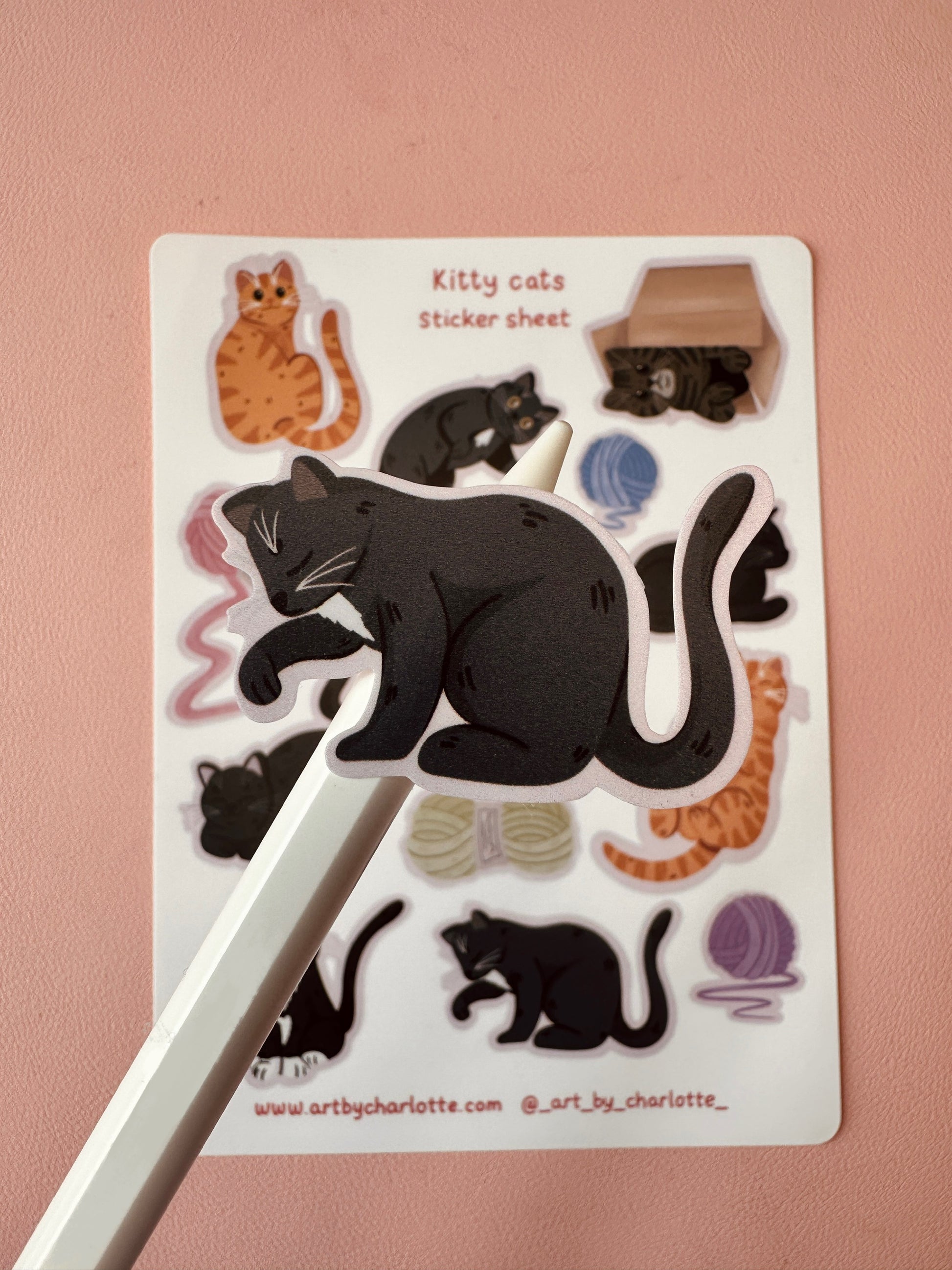 Sticker sheet with cat illustrations on a pink background