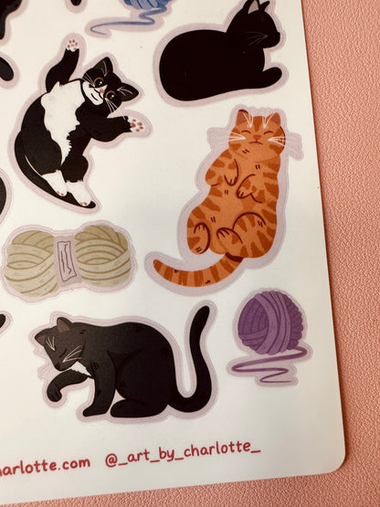 Sticker sheet with cat illustrations and yarn balls on a white background